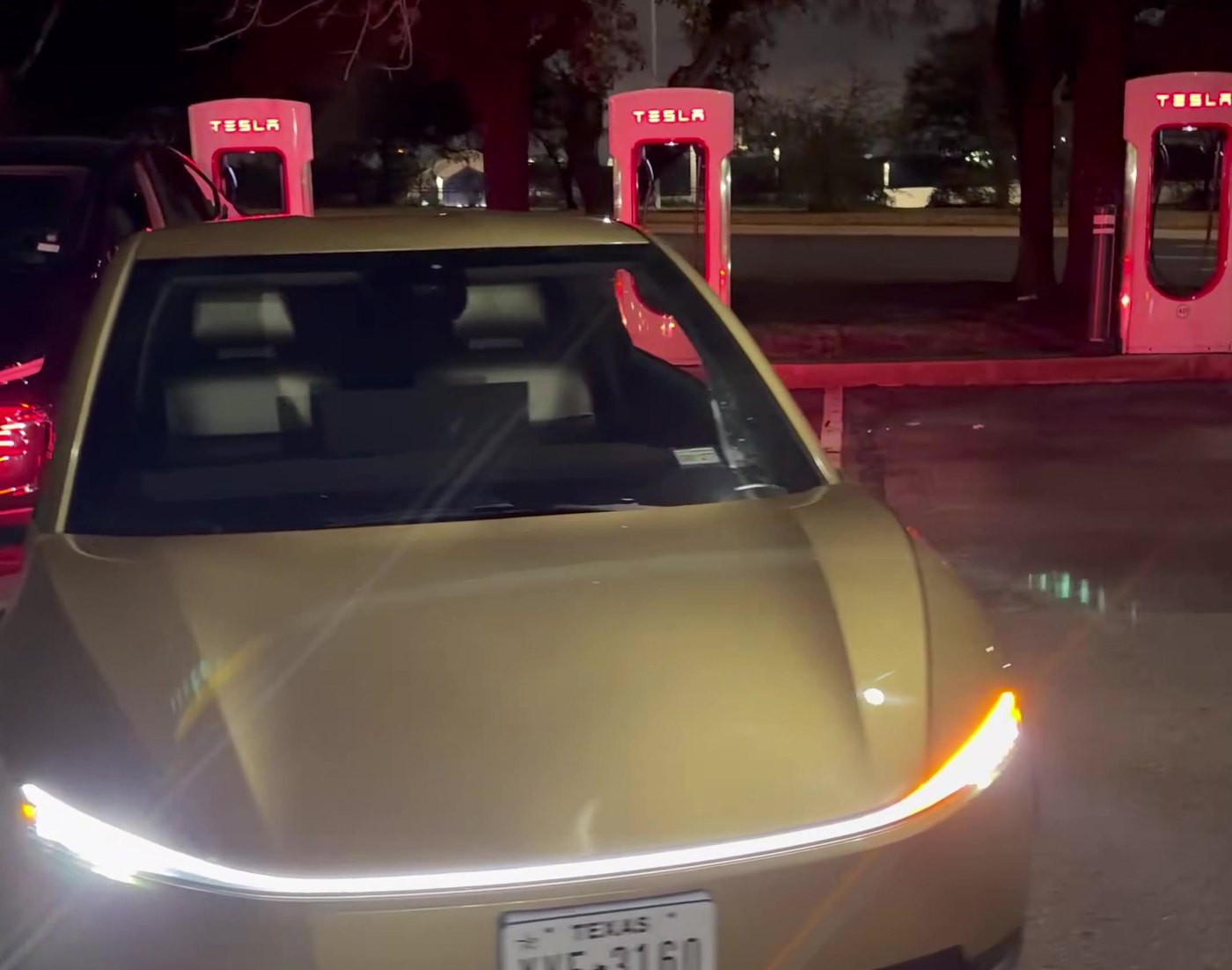 The Cybercab backed into its Supercharger stall in Austin, ready for the cable. Frame from video via @WorldlyReviewer / X