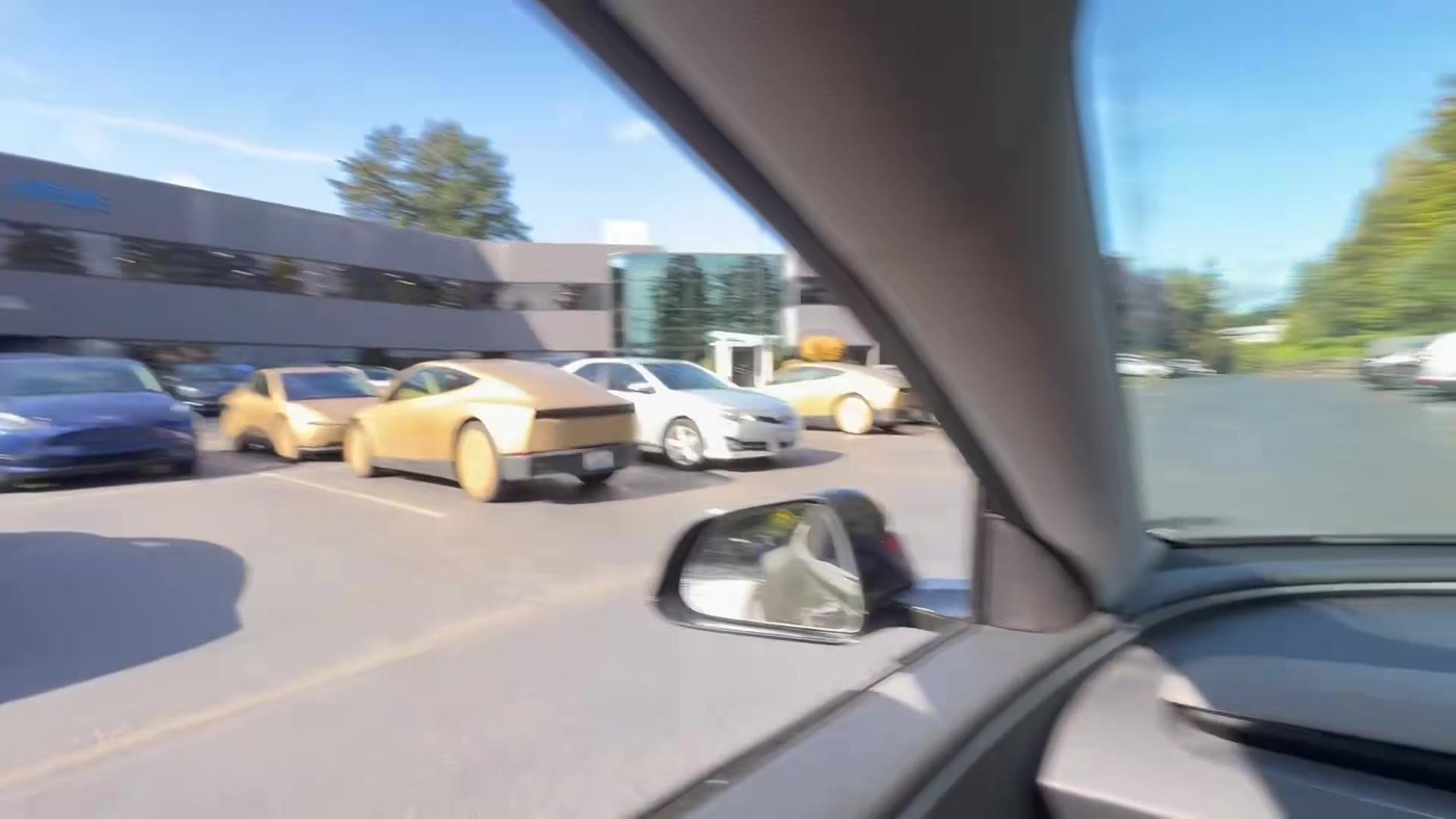 Gold Cybercabs parked by the Overlake 520 East sign in Bellevue, Washington. Video still via @MatthewDR / X
