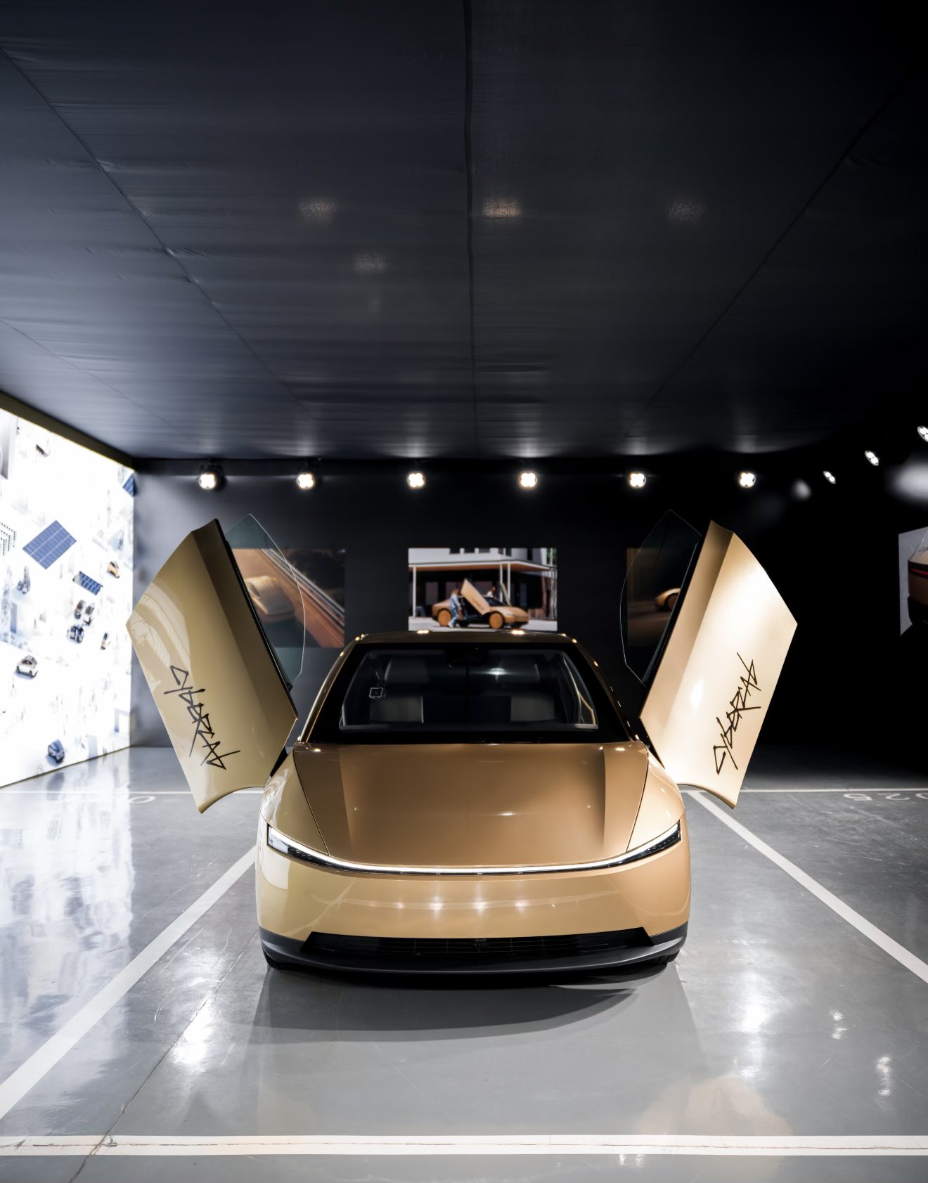 Cybercab on a China store exhibit floor with butterfly doors open.