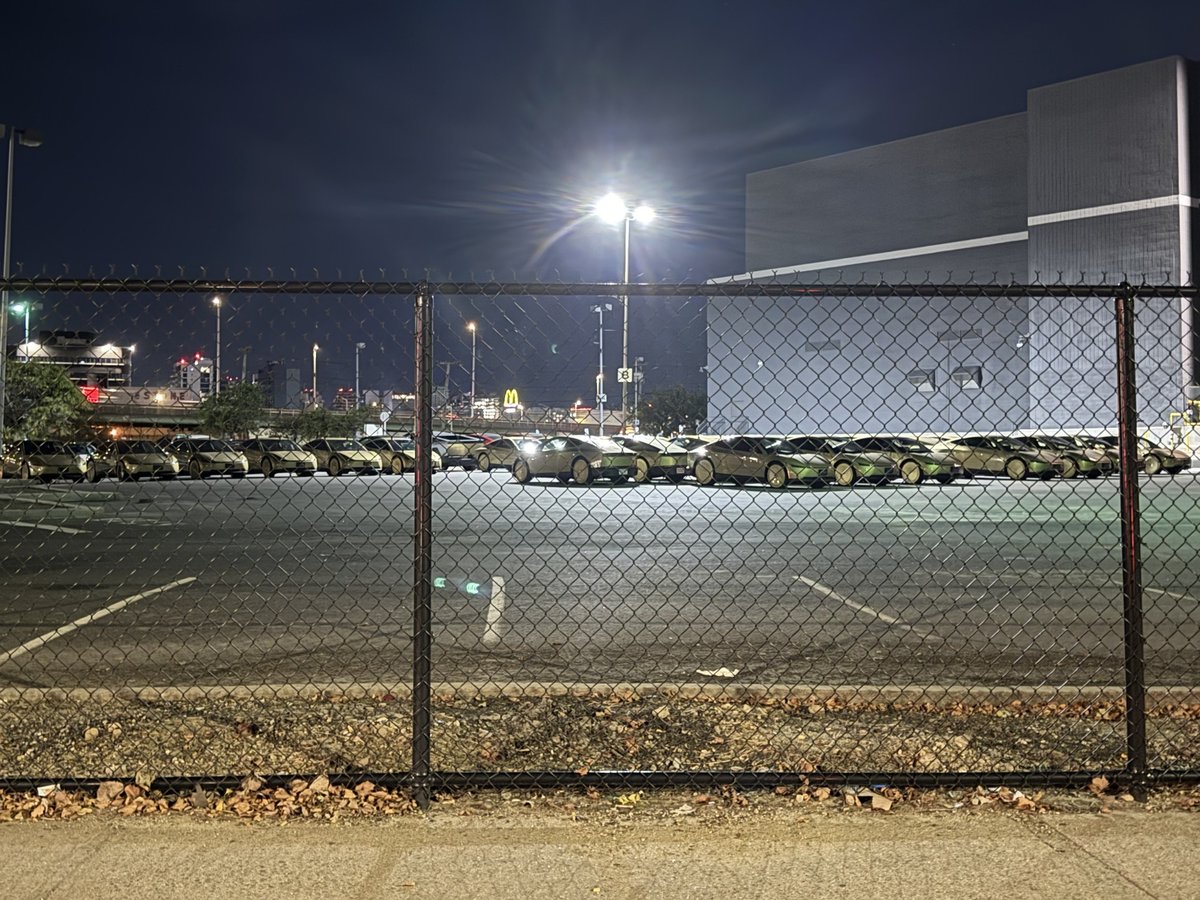 Cybercabs parked in a lot in Queens on Tuesday night. Photo via @rickster902 / X