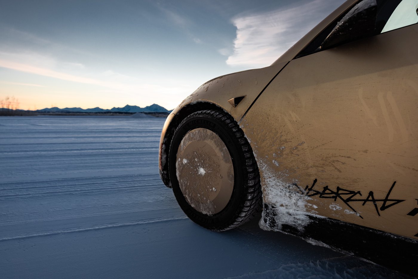 Snow packed into a Cybercab's front wheel arch during Tesla's Alaska winter testing in January. Photo via @robotaxi / X