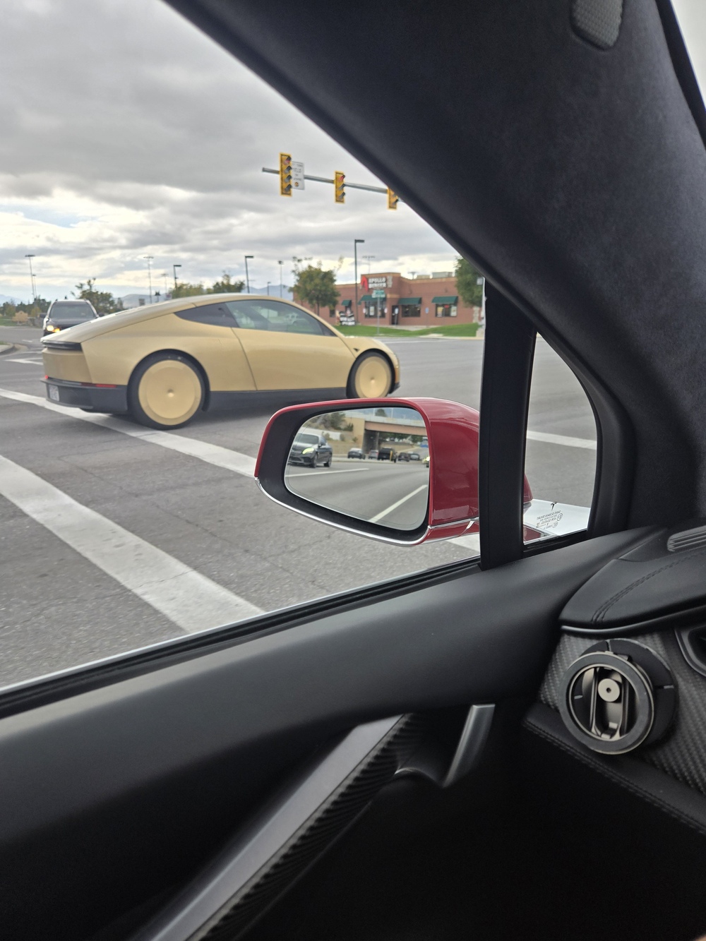 A Cybercab crossing an intersection in Salt Lake City on Wednesday, seen from a passing car. Image via @goldeneggie / X