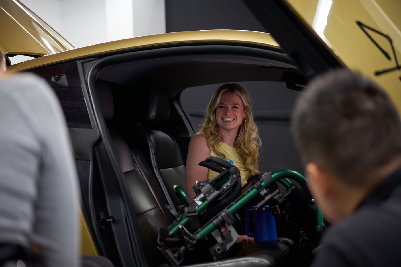 A rider settles into a Cybercab beside her folded wheelchair during Tesla's Accessibility Day. Photo via @robotaxi / X