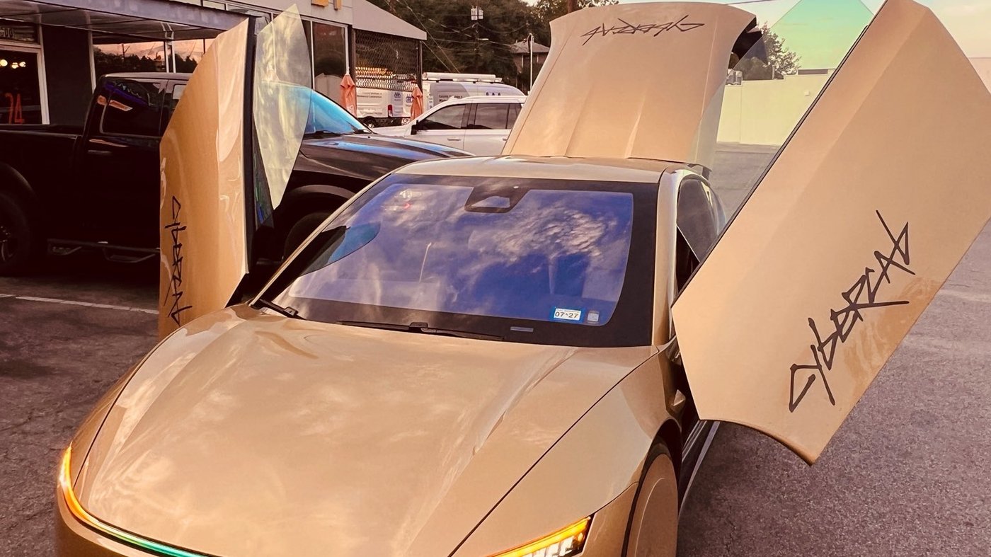 A gold Tesla Cybercab on an Austin street