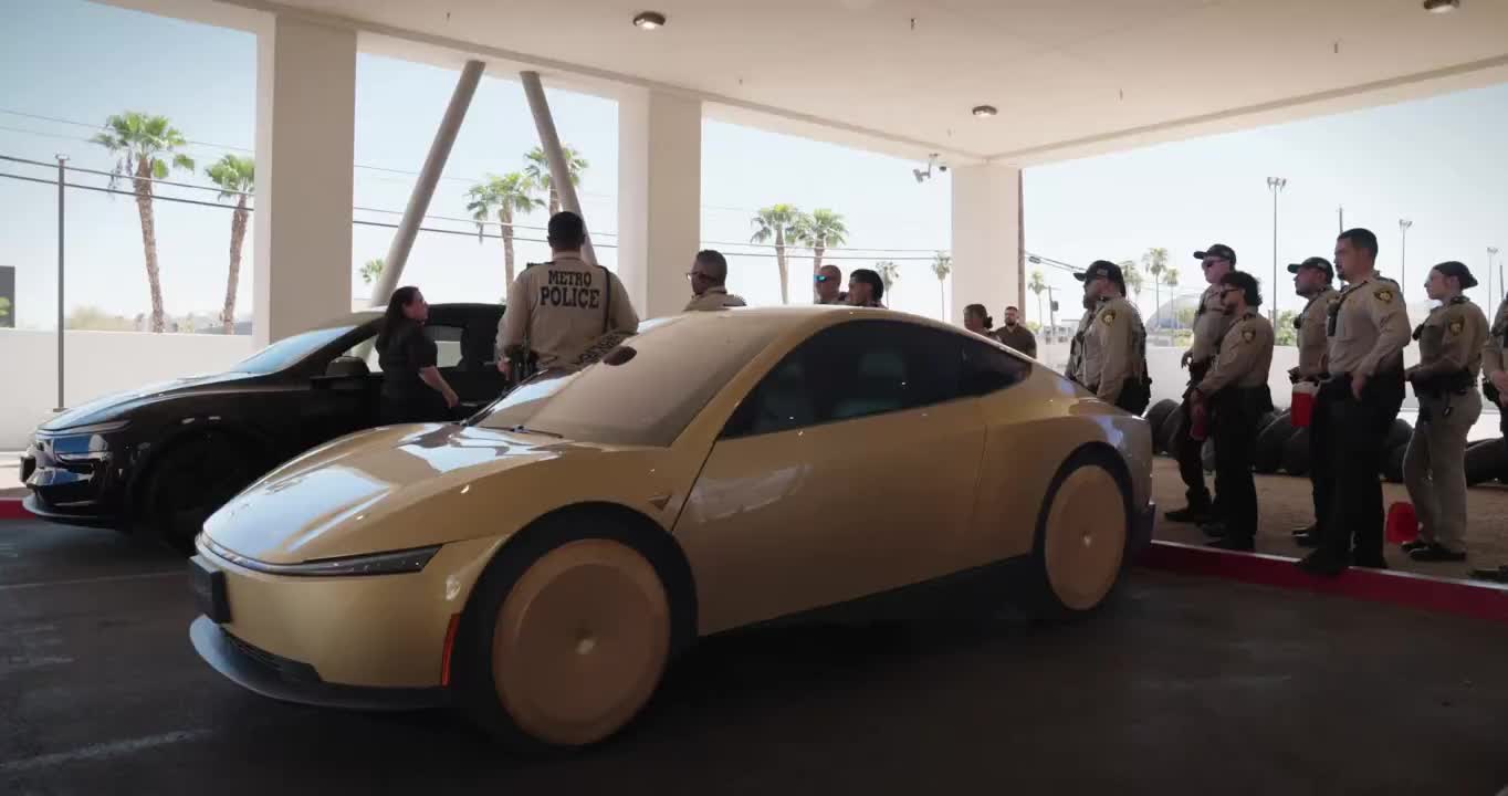 Gold Cybercab on an Austin-area road at night with butterfly doors open.