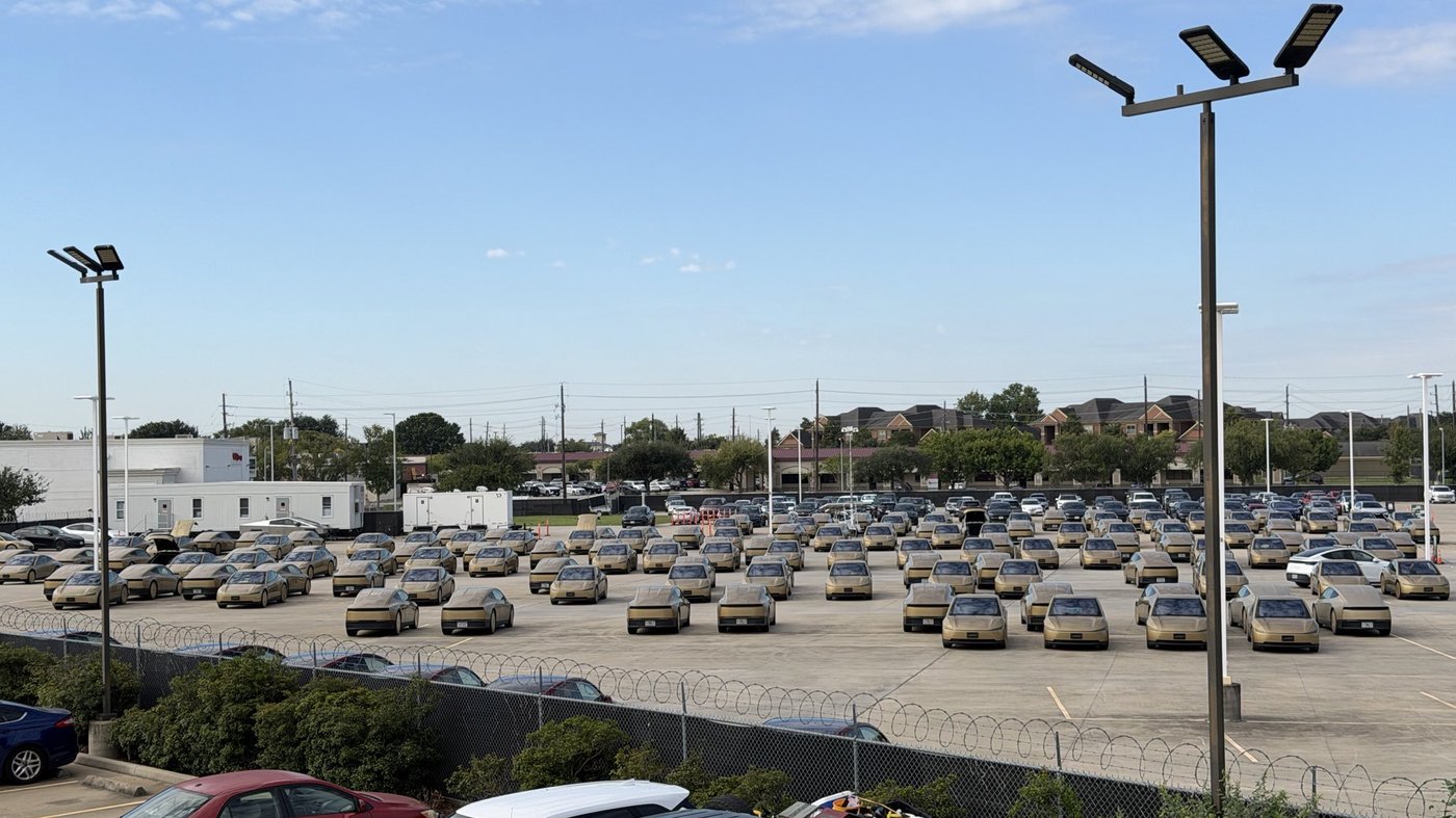 Rows of gold Tesla Cybercabs parked in a lot in Houston