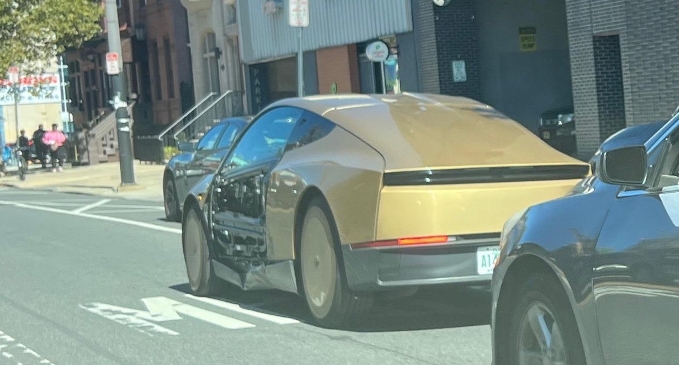 The Cybercab on South Broad Street with a dark sedan stopped behind it. Photo by ryephila via Reddit, shared by @RobotaxiRadar / X