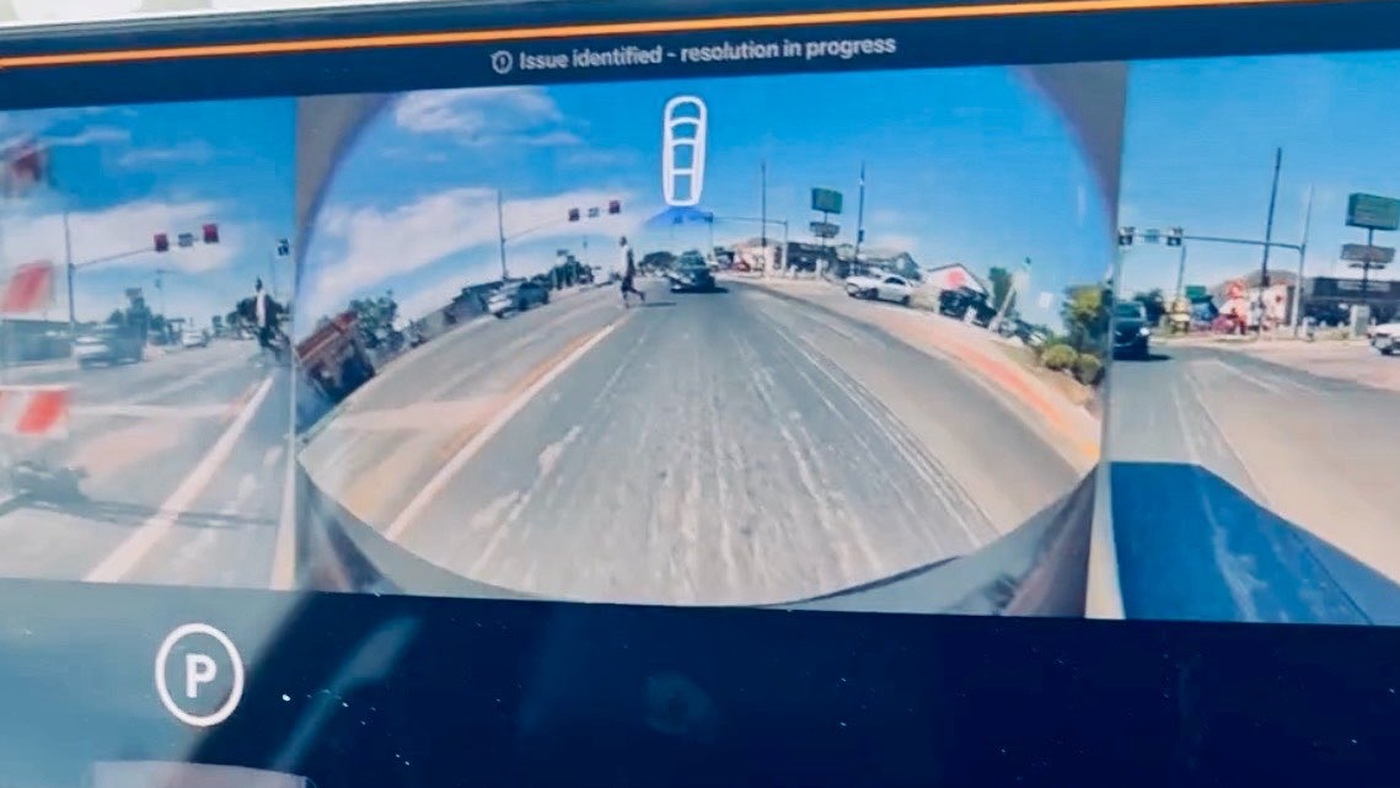 A Cybercab cabin screen with the banner Issue identified - resolution in progress above a wide camera view of an Austin road