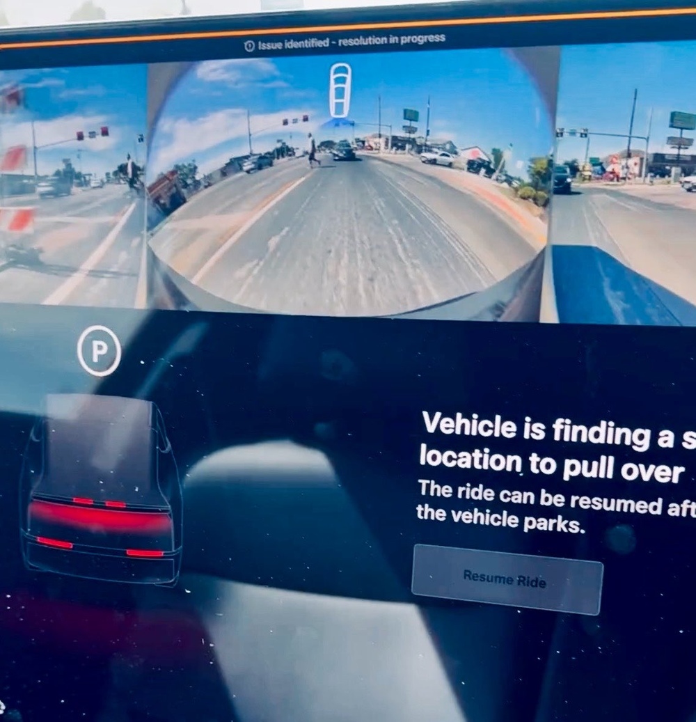 The full Cybercab screen: "Vehicle is finding a safe location to pull over. The ride can be resumed after the vehicle parks," with a Resume Ride button. Image via @Kristennetten / X